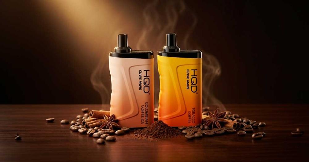Two HQD Cuvie Mars 8000 disposable vapes in Colombian Coffee Ice and Tobacco Coffee flavors, standing side by side on a dark wood table surrounded by roasted coffee beans, ground coffee, cinnamon sticks, and star anise