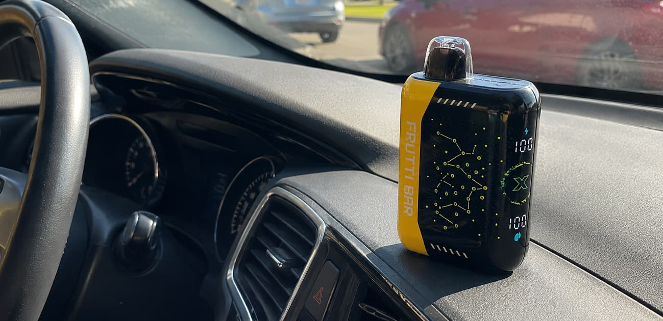 Disposable vape left inside a hot car illustrating the effects of high temperatures on battery safety, e-liquid, and device performance.