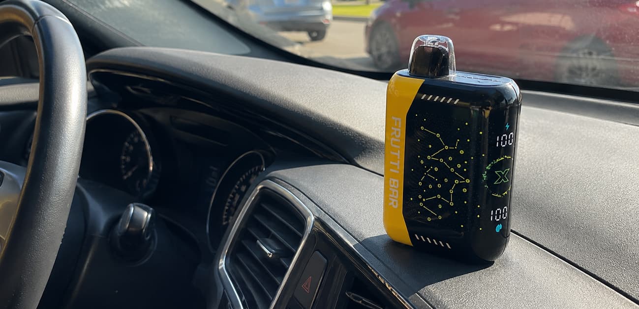 Disposable vape left inside a hot car illustrating the effects of high temperatures on battery safety, e-liquid, and device performance.